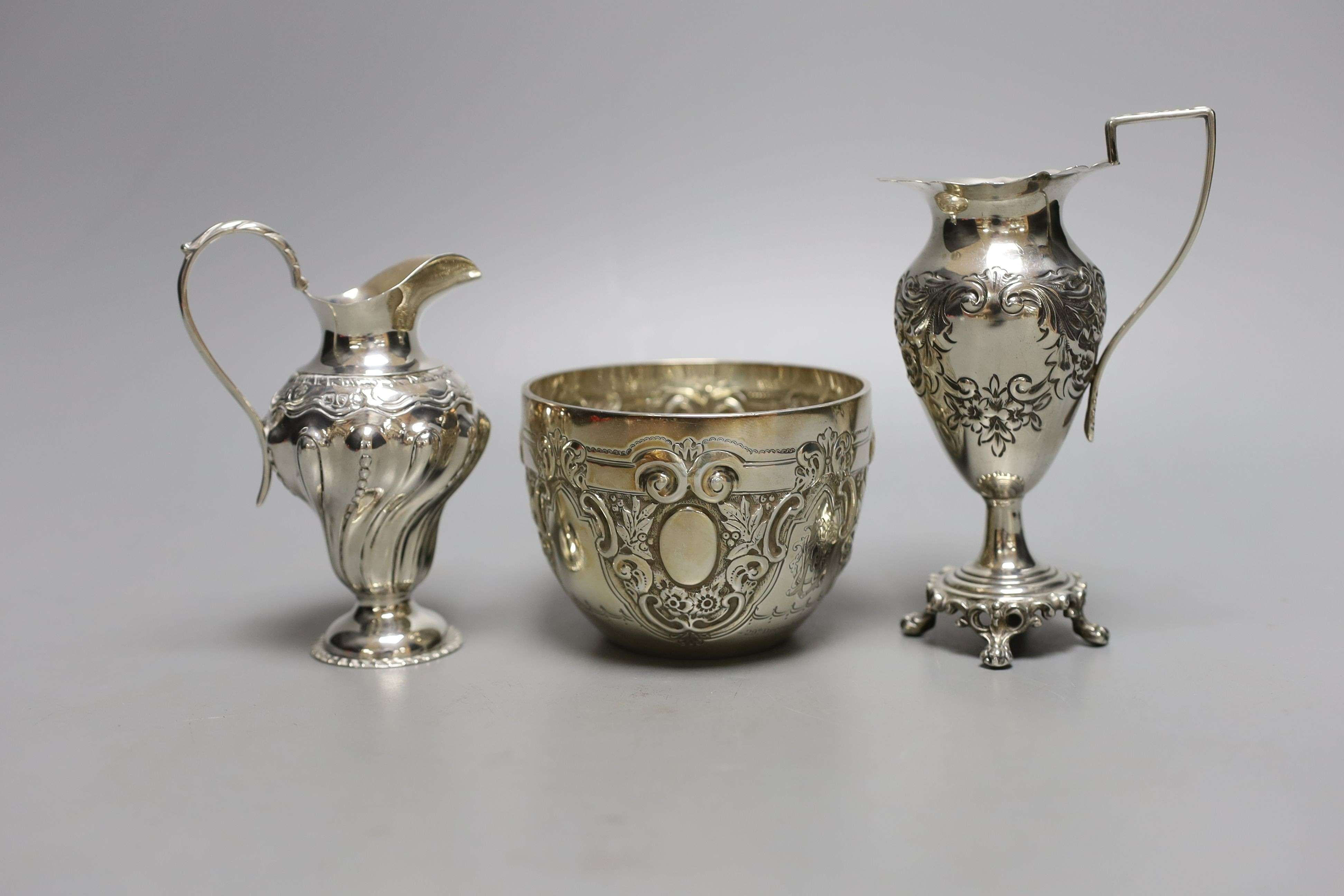 Two late 19th/early 20th century silver cream jugs, 13.5cm, and a late Victorian silver sugar bowl, 10oz.